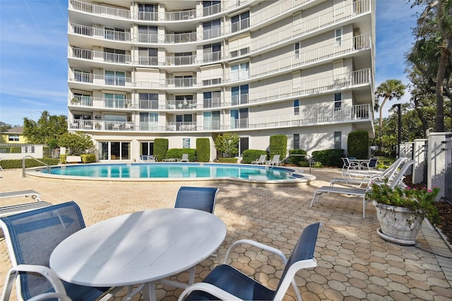 pool featuring a patio and outdoor dining space