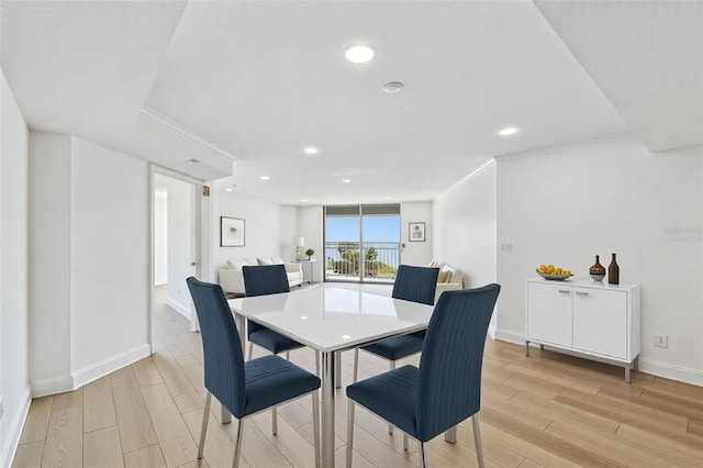 dining space featuring light wood-style flooring, recessed lighting, and baseboards