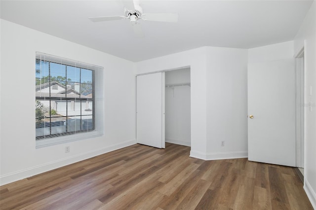 unfurnished bedroom featuring a closet, baseboards, and wood finished floors