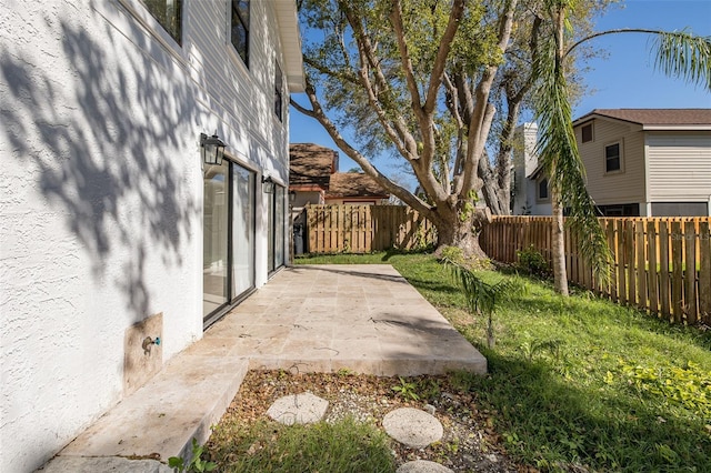 view of yard featuring a patio area and a fenced backyard