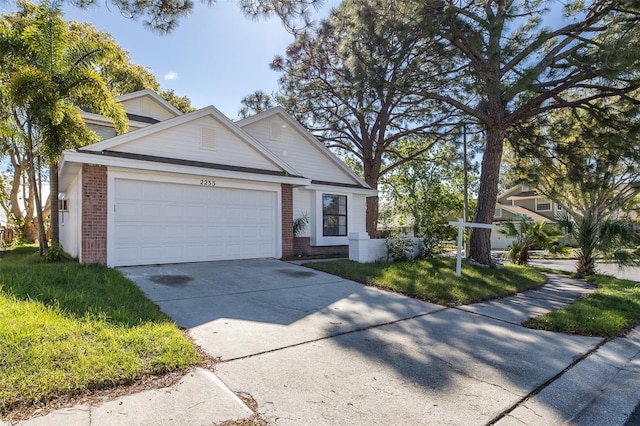 view of front of property with brick siding, driveway, and an attached garage