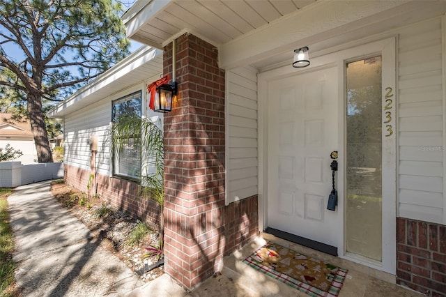 property entrance featuring brick siding