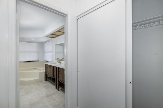 bathroom with a bath and vanity