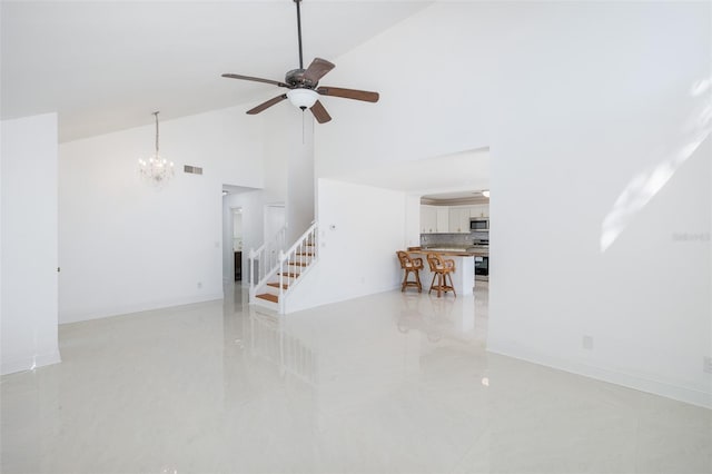 unfurnished living room with high vaulted ceiling, baseboards, stairs, and visible vents