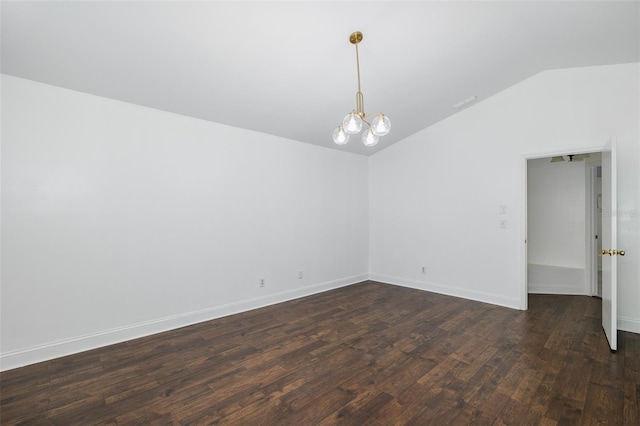 unfurnished room featuring dark wood-style floors, a notable chandelier, vaulted ceiling, and baseboards