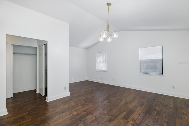 unfurnished bedroom featuring a chandelier, dark wood-type flooring, vaulted ceiling, and baseboards