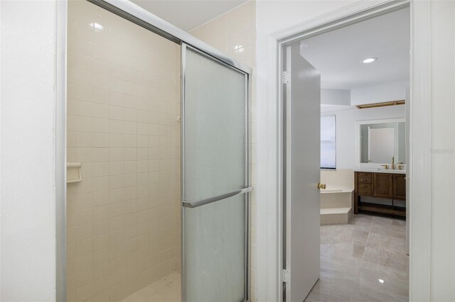 full bathroom with a garden tub, recessed lighting, a shower stall, vanity, and tile patterned flooring