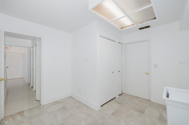 spare room featuring visible vents and baseboards