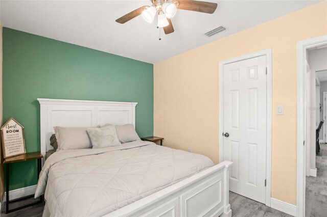 bedroom with visible vents, ceiling fan, baseboards, and light wood-style floors