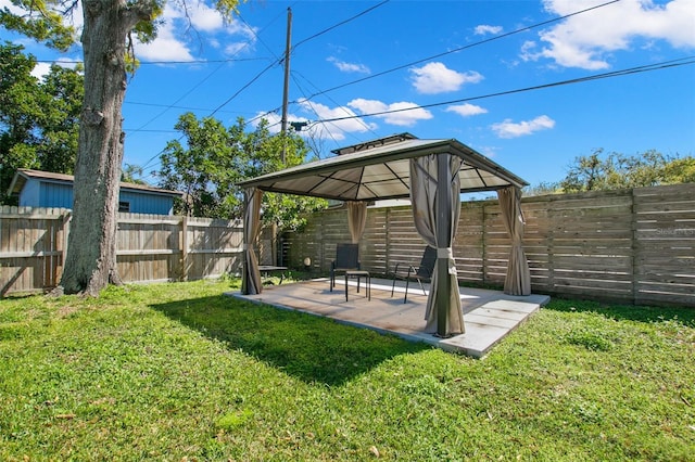 view of yard featuring a gazebo, a fenced backyard, and a patio area