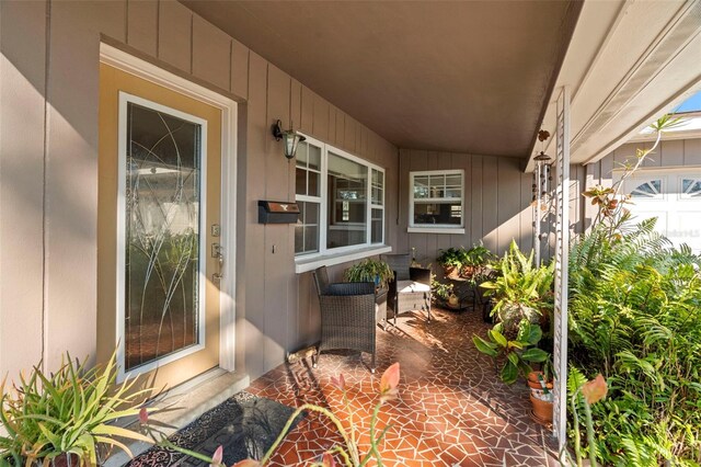 property entrance featuring board and batten siding