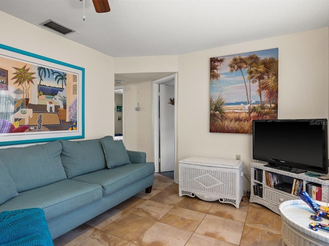 living area featuring ceiling fan and visible vents