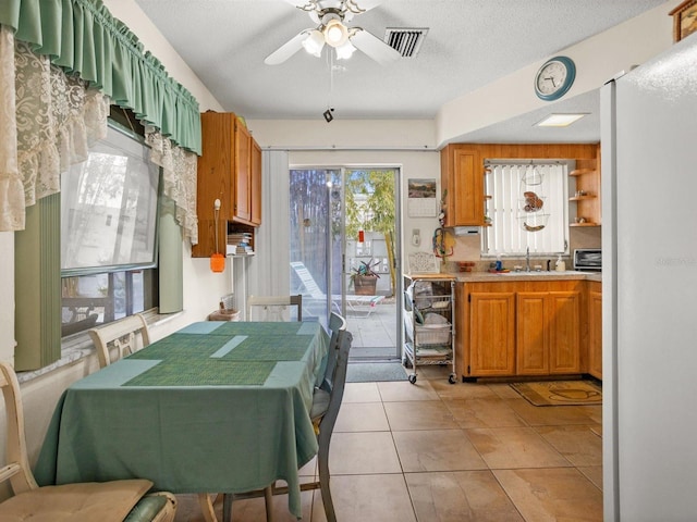 kitchen featuring a wealth of natural light, light countertops, visible vents, and light tile patterned floors