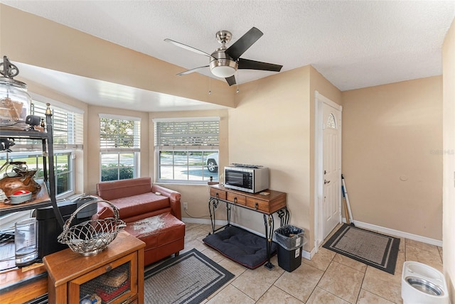 interior space with ceiling fan