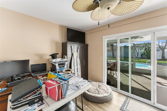 office area with light wood-type flooring and ceiling fan