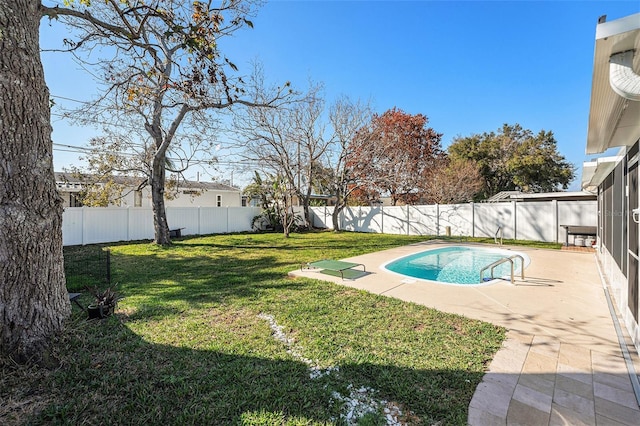 view of pool featuring a patio area, a fenced backyard, a fenced in pool, and a yard