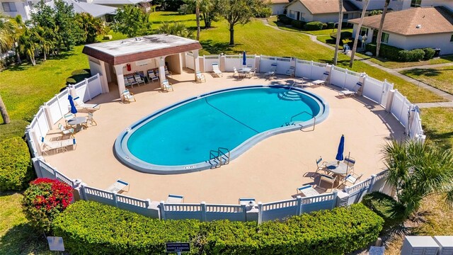 pool with a fenced backyard and a patio