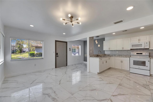 kitchen featuring marble finish floor, white appliances, backsplash, and visible vents