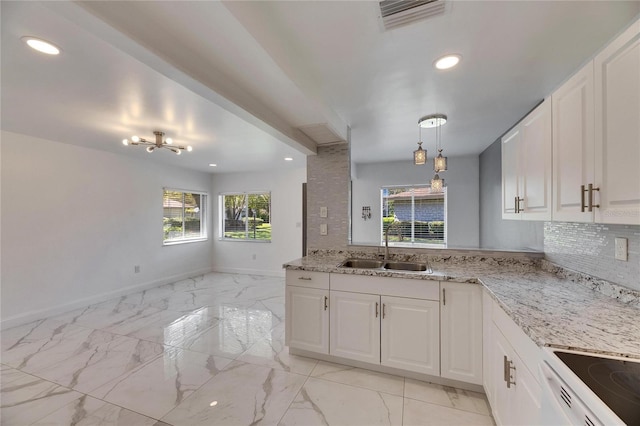 kitchen featuring marble finish floor, tasteful backsplash, a sink, and visible vents