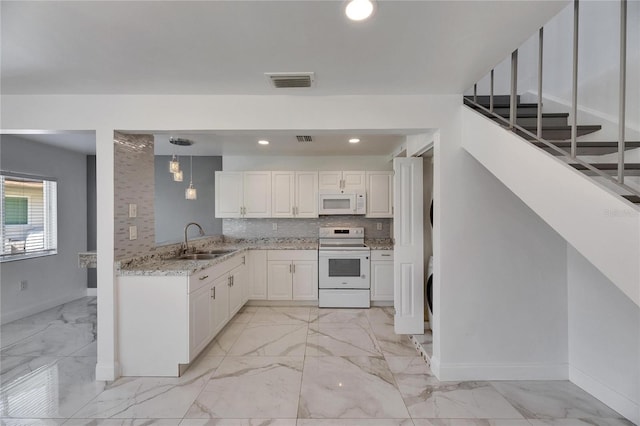 kitchen featuring white appliances, visible vents, marble finish floor, and a sink