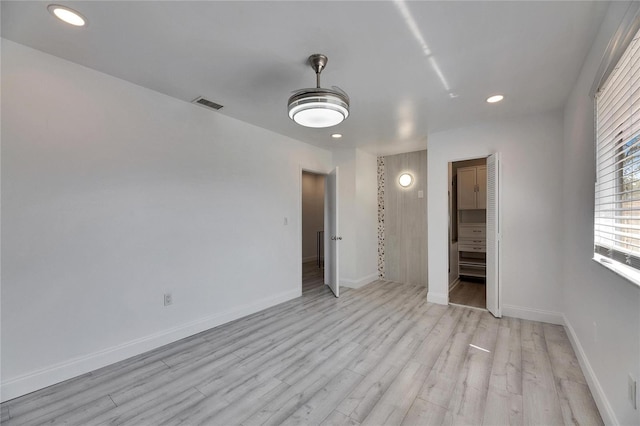 unfurnished bedroom with light wood-style floors, recessed lighting, visible vents, and baseboards