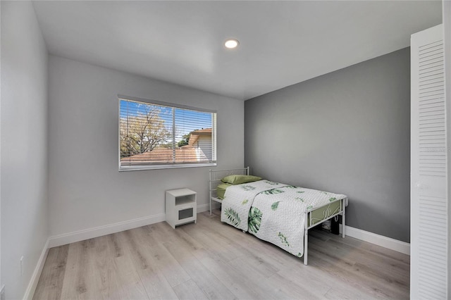 bedroom featuring wood finished floors and baseboards