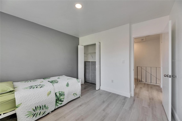 bedroom with baseboards, a closet, recessed lighting, and light wood-style floors