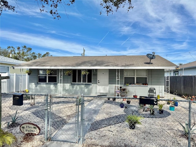 single story home featuring a fenced front yard, a gate, and a porch