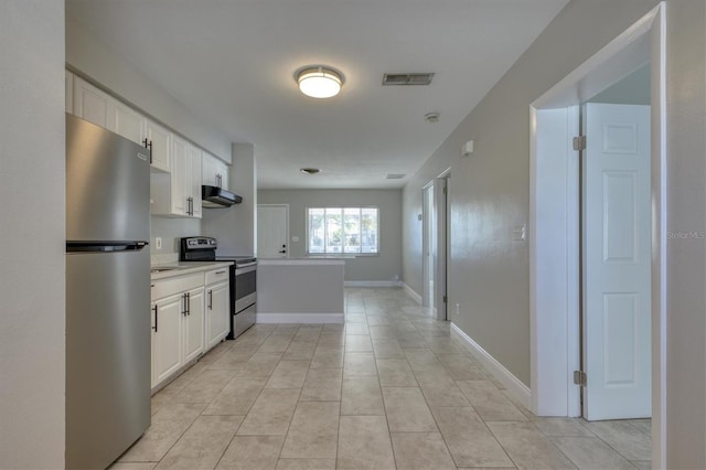 kitchen with under cabinet range hood, white cabinetry, visible vents, and stainless steel appliances