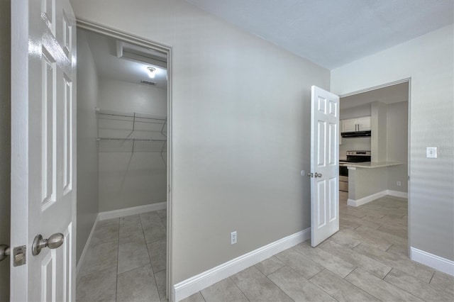 interior space featuring tile patterned floors, baseboards, and visible vents