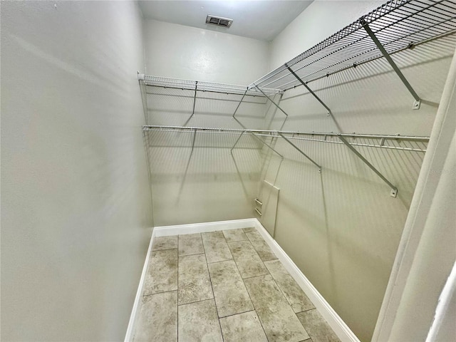 spacious closet featuring tile patterned flooring and visible vents