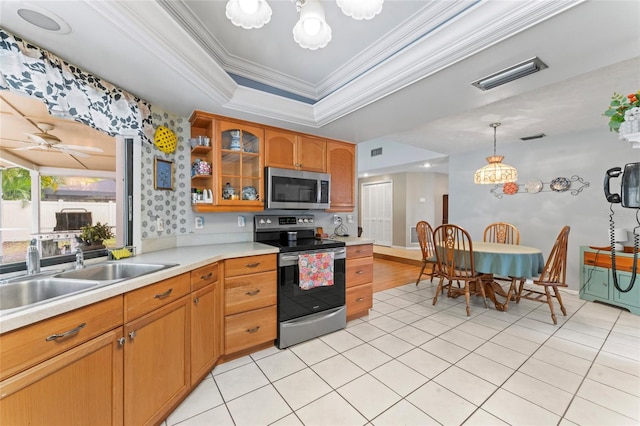 kitchen with a raised ceiling, light countertops, visible vents, appliances with stainless steel finishes, and a sink