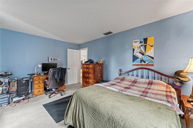 bedroom featuring carpet, visible vents, and a textured ceiling