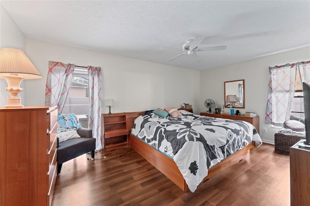 bedroom with ceiling fan, a textured ceiling, and wood finished floors