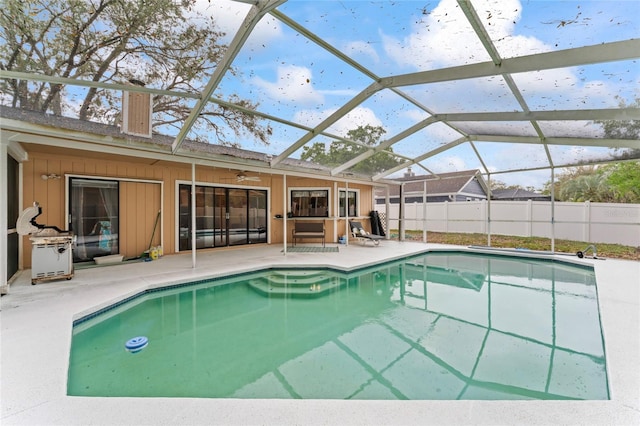 view of pool featuring a patio, glass enclosure, fence, and a fenced in pool