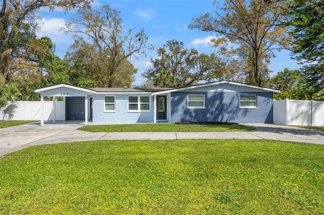 view of front of property with fence, a front lawn, concrete driveway, and brick siding