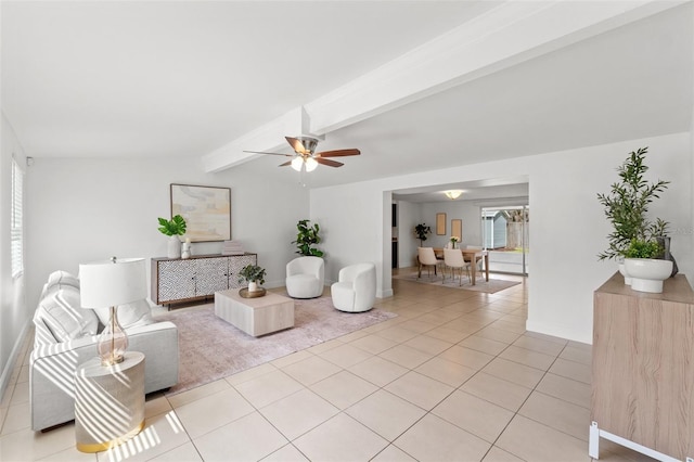 living area with vaulted ceiling with beams, ceiling fan, baseboards, and light tile patterned flooring