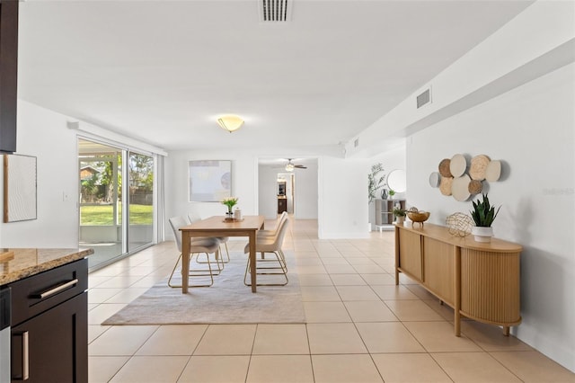 dining room with ceiling fan, visible vents, and light tile patterned flooring