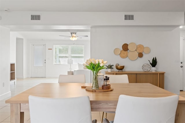 dining area featuring visible vents, ceiling fan, baseboards, and light tile patterned flooring