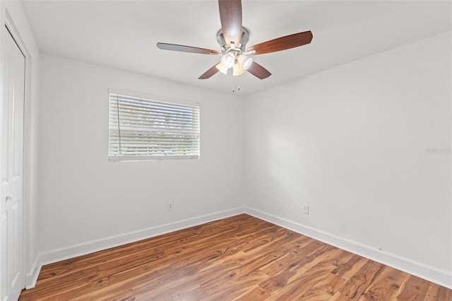 spare room with ceiling fan, baseboards, and wood finished floors