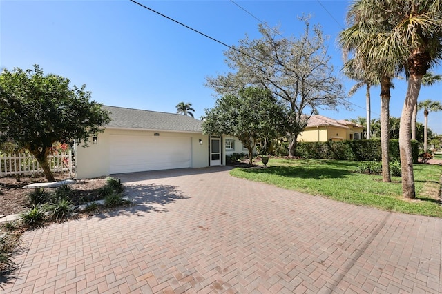 27150 Del Ln, Bonita Springs, FL 34135 - ranch-style house with a front lawn, decorative driveway, an attached garage, and stucco siding