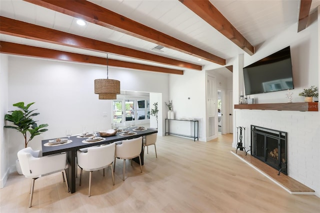 27150 Del Ln, Bonita Springs, FL 34135 - dining area with visible vents, a fireplace, beamed ceiling, and wood finished floors