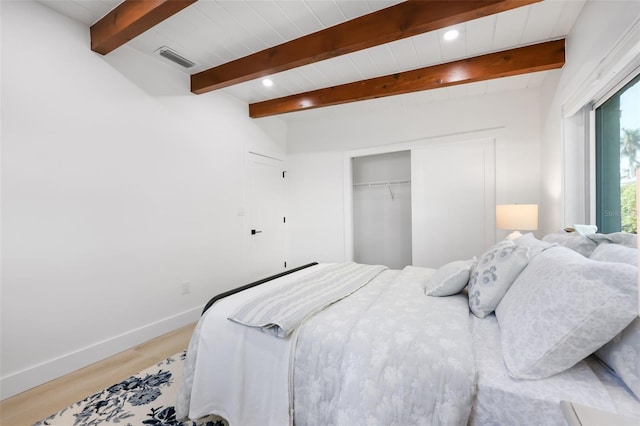 27150 Del Ln, Bonita Springs, FL 34135 - bedroom featuring beam ceiling, a closet, visible vents, light wood-style flooring, and baseboards