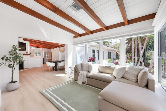27150 Del Ln, Bonita Springs, FL 34135 - living area featuring vaulted ceiling with beams, plenty of natural light, visible vents, and wood finished floors