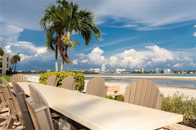 view of patio / terrace featuring a water view and a city view