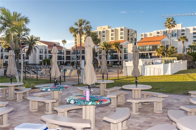 view of property's community with a yard, a patio area, and fence