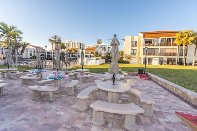 surrounding community featuring a lawn and a patio