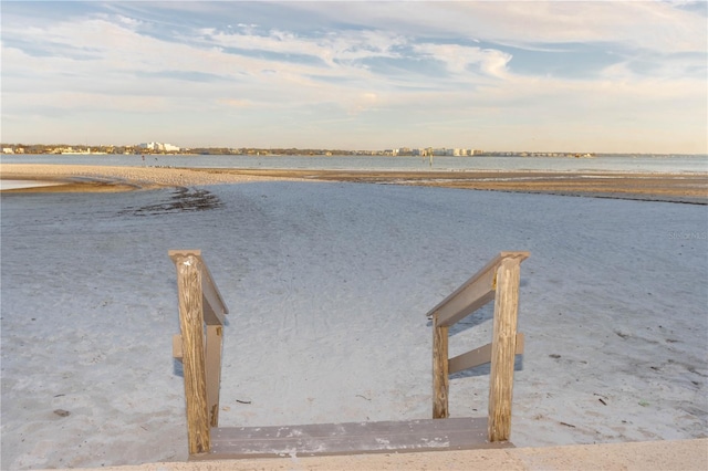 view of dock featuring a view of the beach and a water view