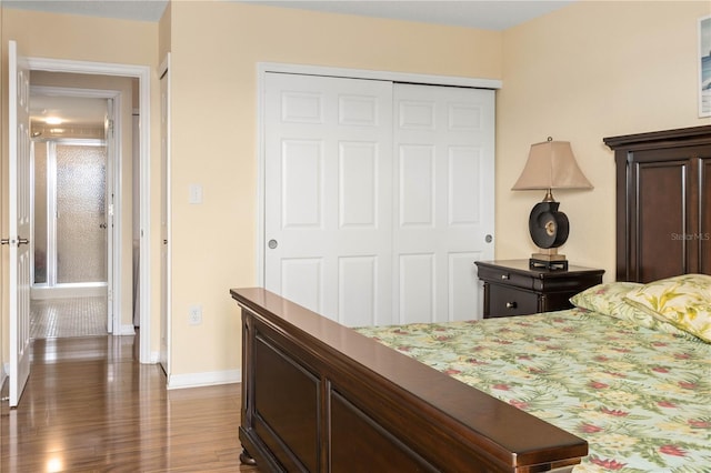 bedroom with a closet, baseboards, and wood finished floors