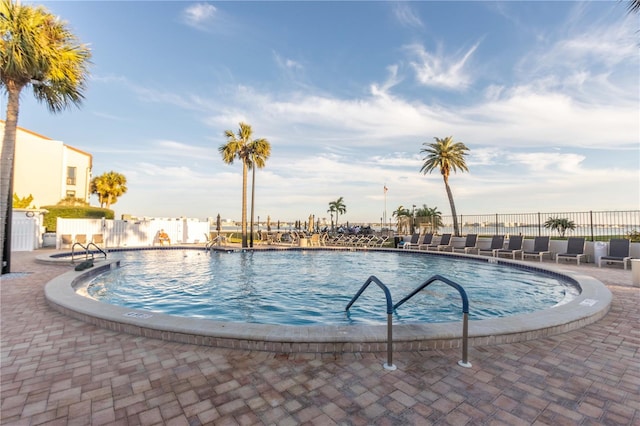 community pool featuring a patio area and fence